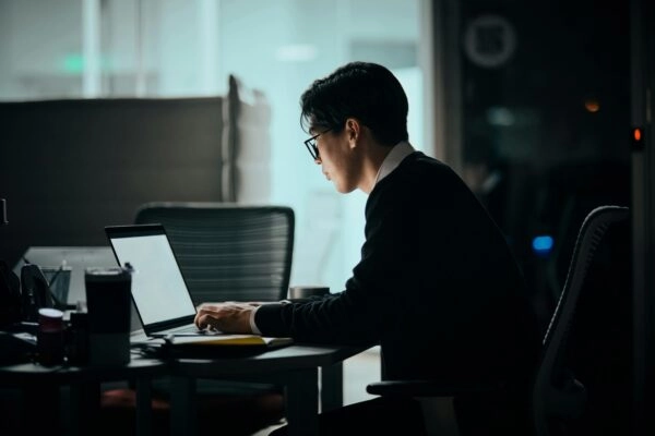 Man at desk using laptop