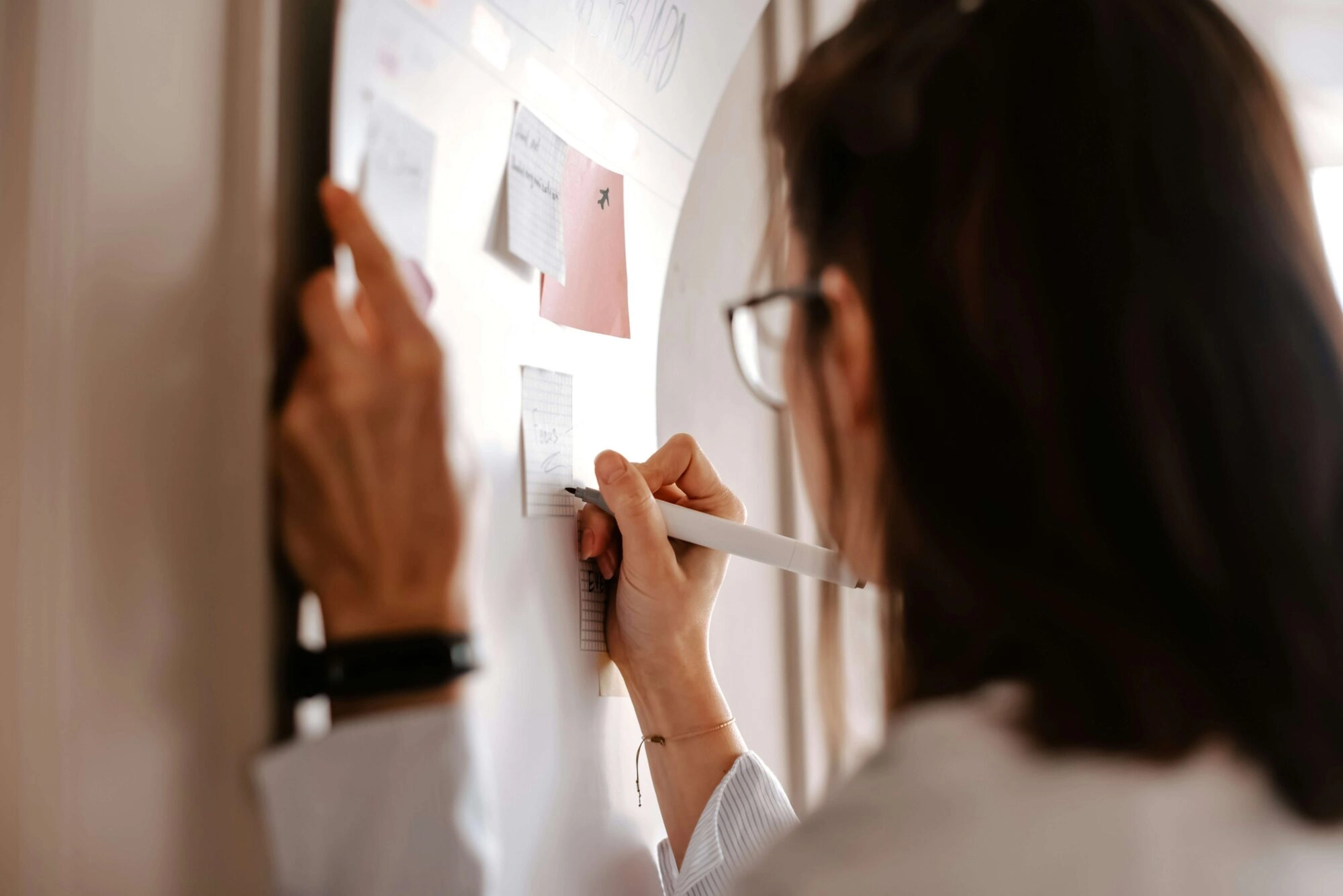 Woman writing on a board during workshop